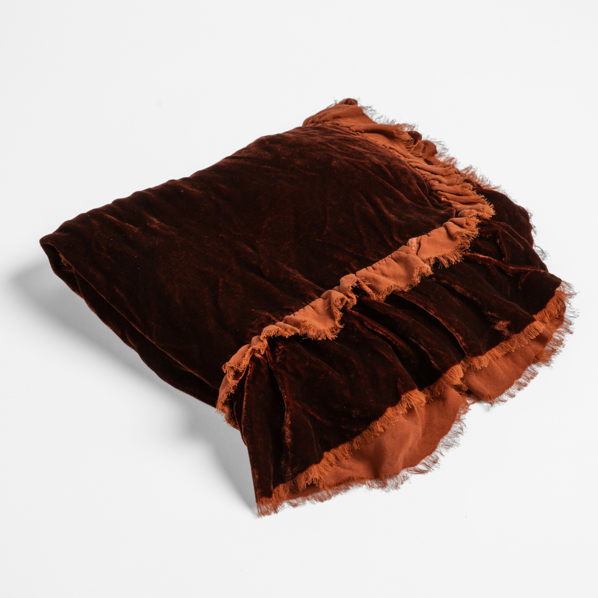 Autumn | A close-up of the corner of a folded Loulah Baby Blanket in Autumn, a rich terracotta tone, shown against a white background.