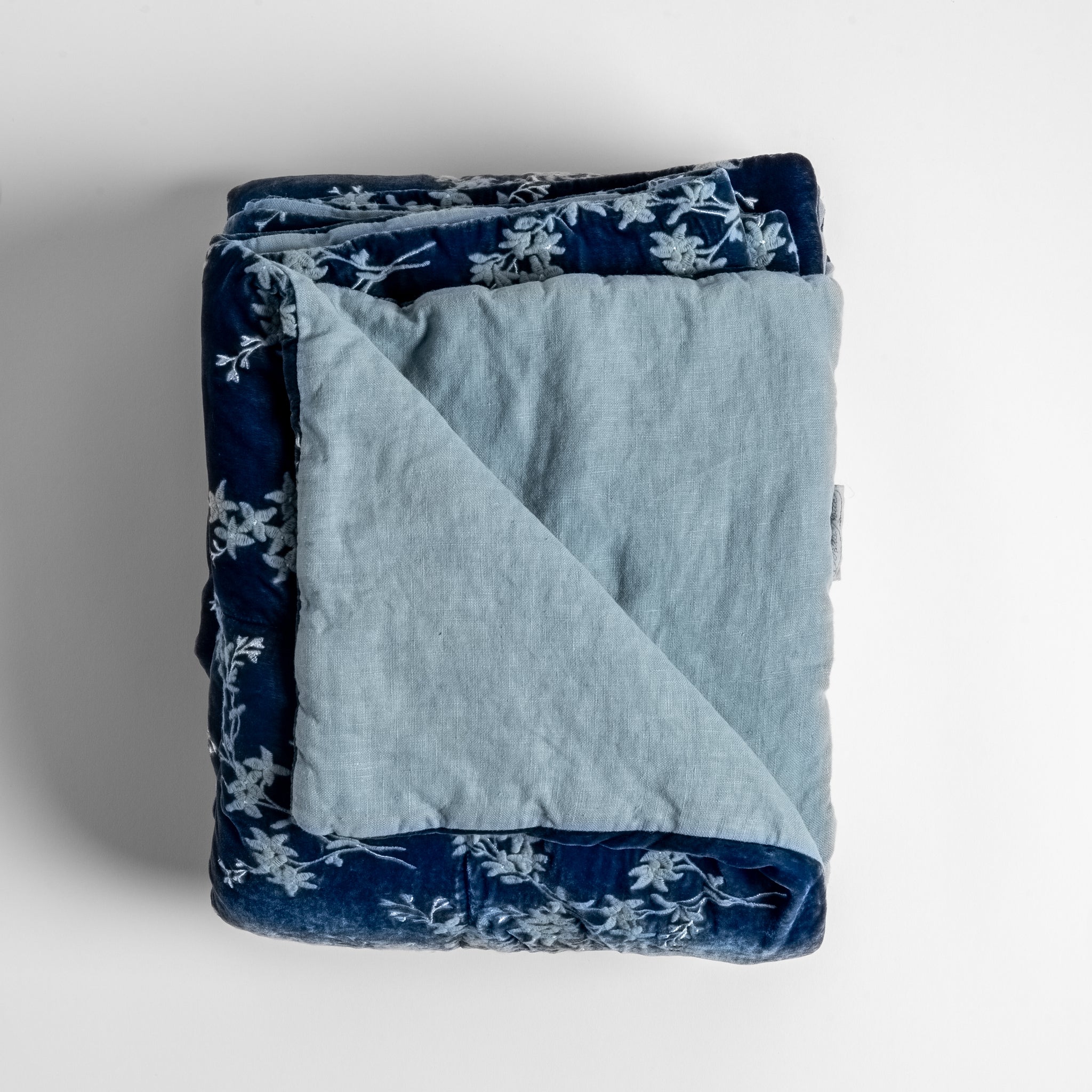 Lynette Blanket | Tahoe Blue | Close up of folded blanket, with a corner turned back to showcase the linen back - overhead view.