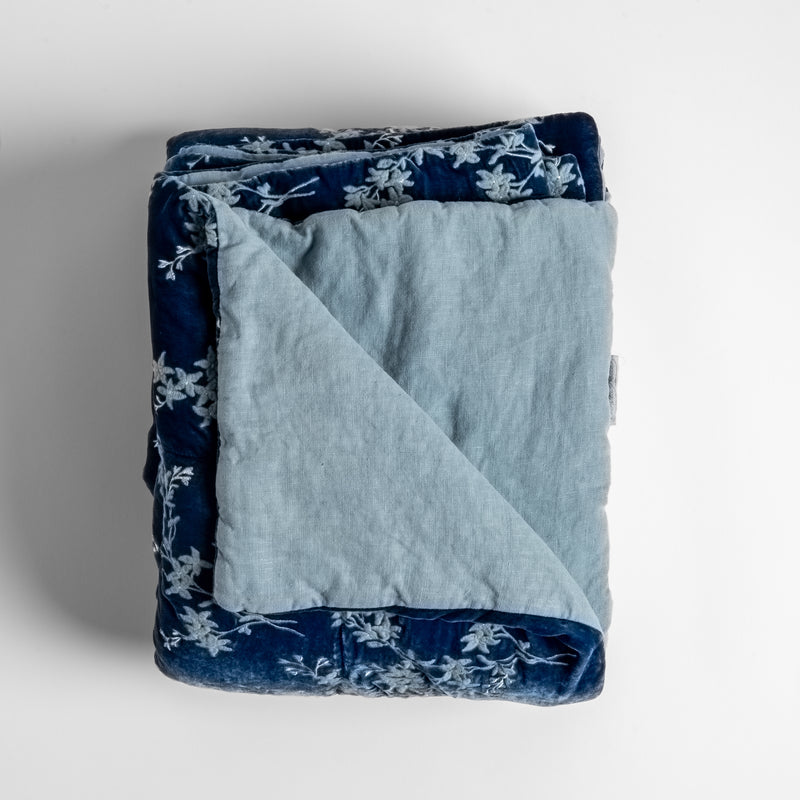 Lynette Blanket | Tahoe Blue | Close up of folded blanket, with a corner turned back to showcase the linen back - overhead view.