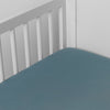 Madera Luxe Crib Sheet | Cenote | crib sheet shown on a mattress shown from overhead into the corner of a crib.