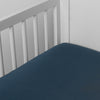 Madera Luxe Crib Sheet | Midnight | crib sheet shown on a mattress shown from overhead into the corner of a crib.