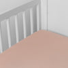 Madera Luxe Crib Sheet | Rouge | crib sheet shown on a mattress shown from overhead into the corner of a crib.