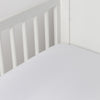 Madera Luxe Crib Sheet | White | crib sheet shown on a mattress shown from overhead into the corner of a crib.