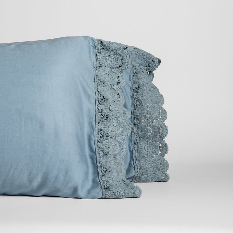 Madera Luxe Pillowcase (Single) | Tahoe Blue | a pair of tencel pillowcases trimmed with cotton lace standing upright against a white background.