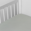 Madera Luxe Crib Sheet | Eucalyptus | crib sheet shown on a mattress shown from overhead into the corner of a crib.