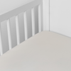 Madera Luxe Crib Sheet | Parchment | crib sheet shown on a mattress shown from overhead into the corner of a crib.