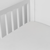 Madera Luxe Crib Sheet | Winter White | crib sheet shown on a mattress shown from overhead into the corner of a crib.