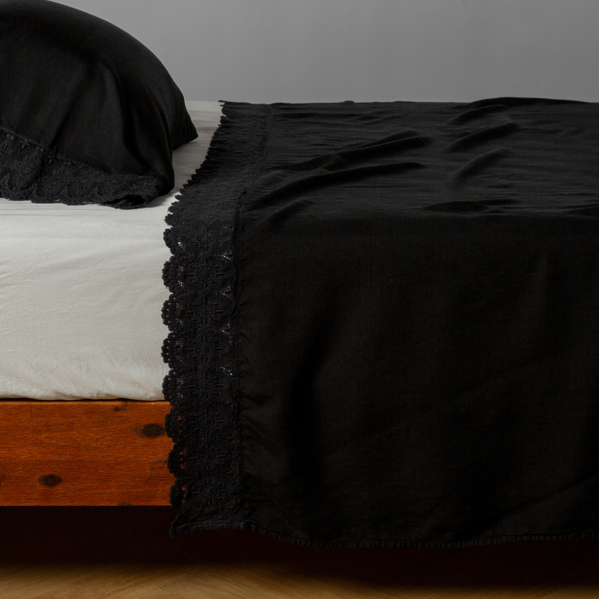 Madera Luxe Flat Sheet | Corvino | matching tencel flat sheet and pillowcase with cotton lace trim on a bed shown from the side