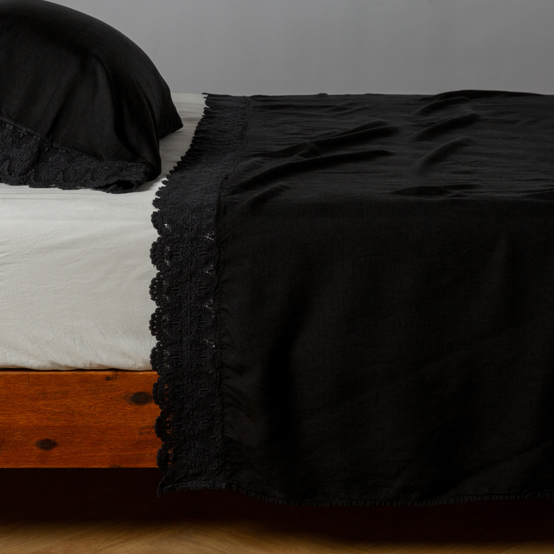 Madera Luxe Flat Sheet | Corvino | matching tencel flat sheet and pillowcase with cotton lace trim on a bed shown from the side