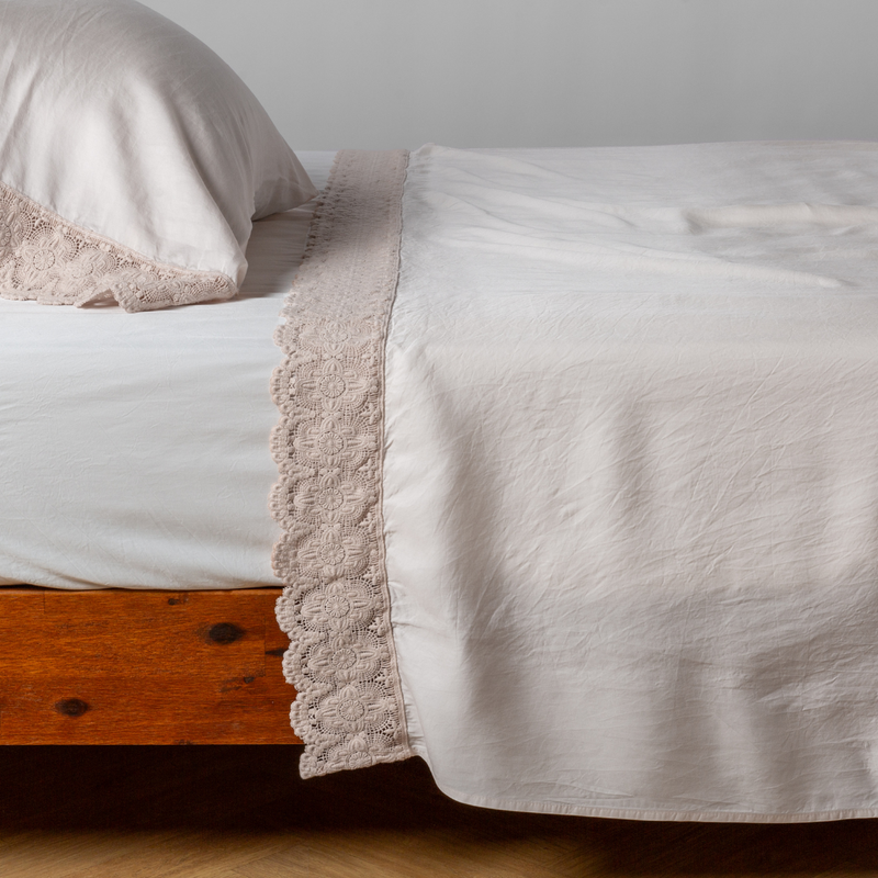 Madera Luxe Flat Sheet | Pearl | matching tencel flat sheet and pillowcase with cotton lace trim on a bed shown from the side