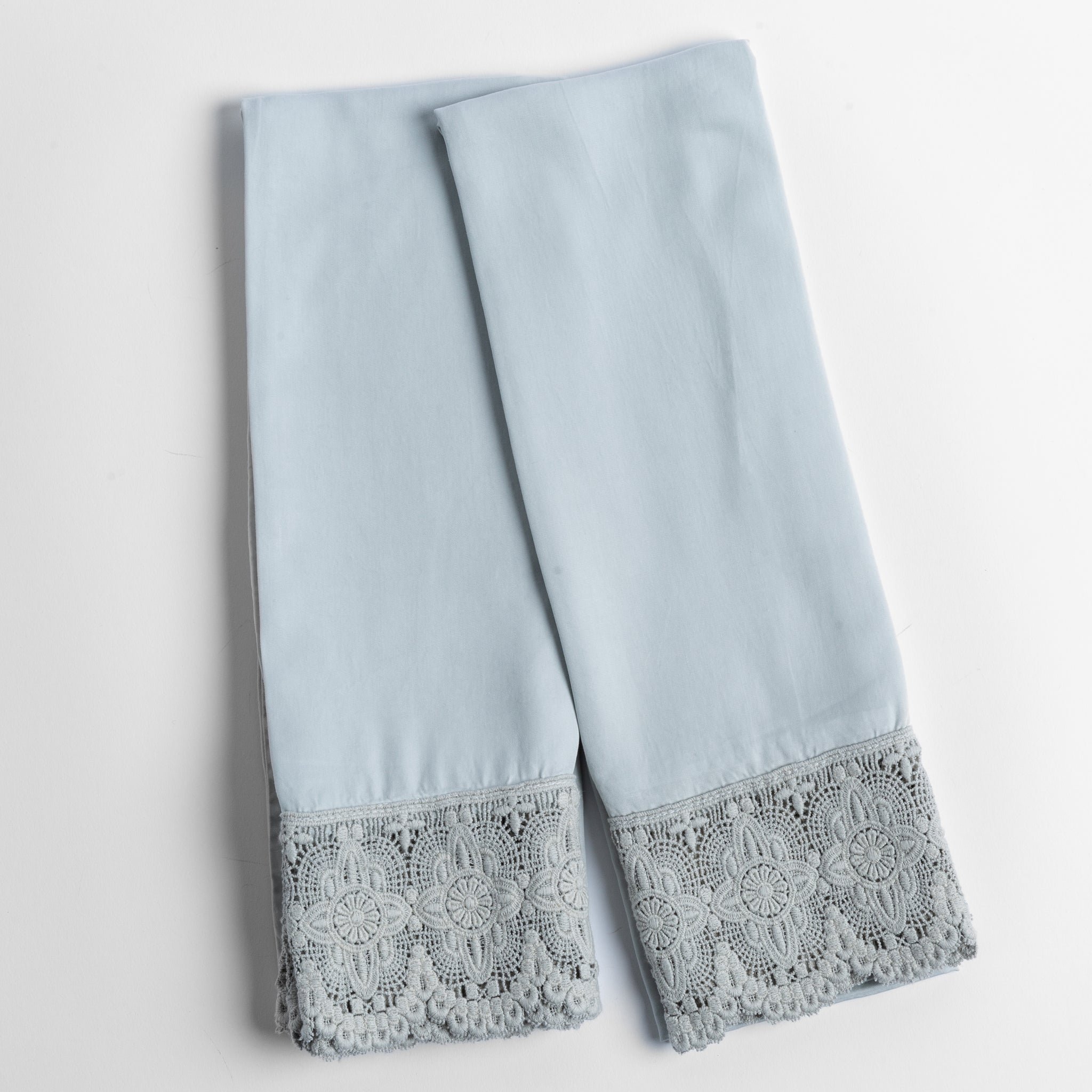 Madera Luxe Pillowcase (Single) | Cloud | a pair of tencel pillowcases trimmed with cotton lace shown overhead against a white background.