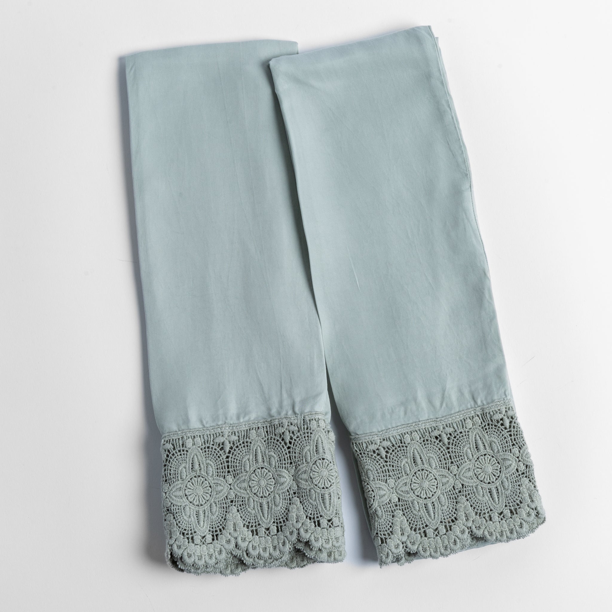 Madera Luxe Pillowcase (Single) | Eucalyptus | a pair of tencel pillowcases trimmed with cotton lace shown overhead against a white background.