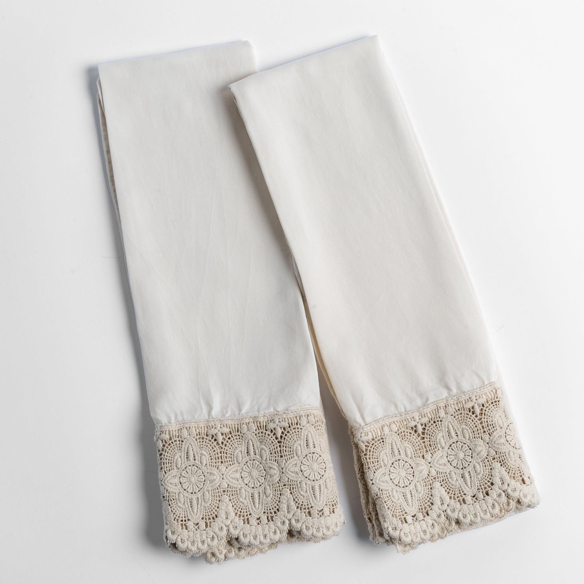 Madera Luxe Pillowcase (Single) | Parchment | a pair of tencel pillowcases trimmed with cotton lace shown overhead against a white background.