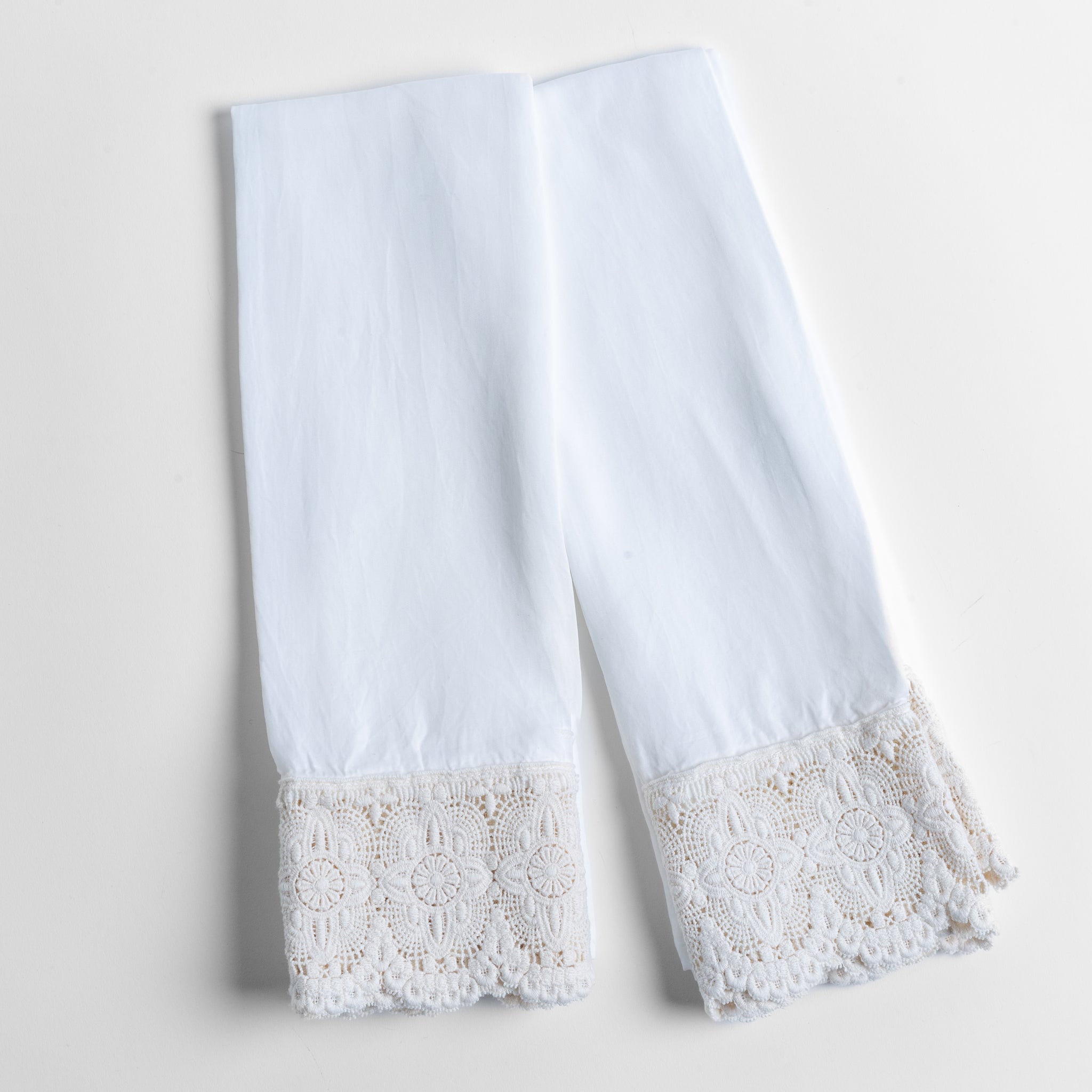 Madera Luxe Pillowcase (Single) | White | a pair of tencel pillowcases trimmed with cotton lace shown overhead against a white background.