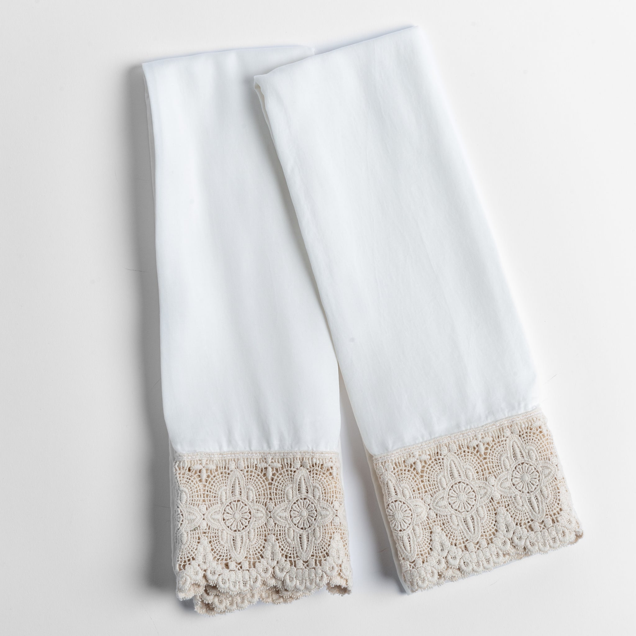 Madera Luxe Pillowcase (Single) | Winter White | a pair of tencel pillowcases trimmed with cotton lace shown overhead against a white background.