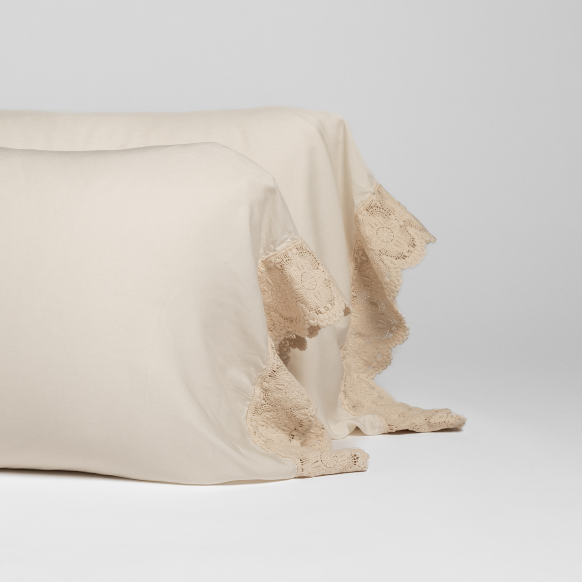 Madera Luxe Pillowcase (Single) | Natural | a pair of tencel pillowcases trimmed with cotton lace.