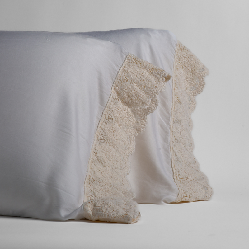 Madera Luxe Pillowcase (Single) | Winter White | a pair of tencel pillowcases trimmed with cotton lace standing upright against a white background.