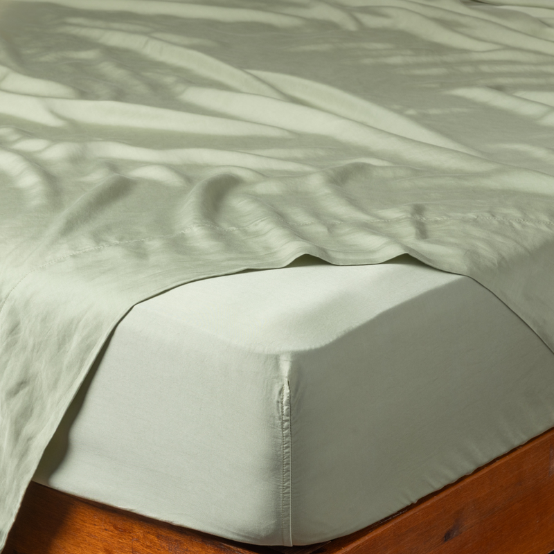 Madera Luxe Twin Fitted Sheets | Desert Sage | a fitted sheet corner in desert sage, a serenely elegant green, offering a hushed hue, shown with a matching flat sheet.