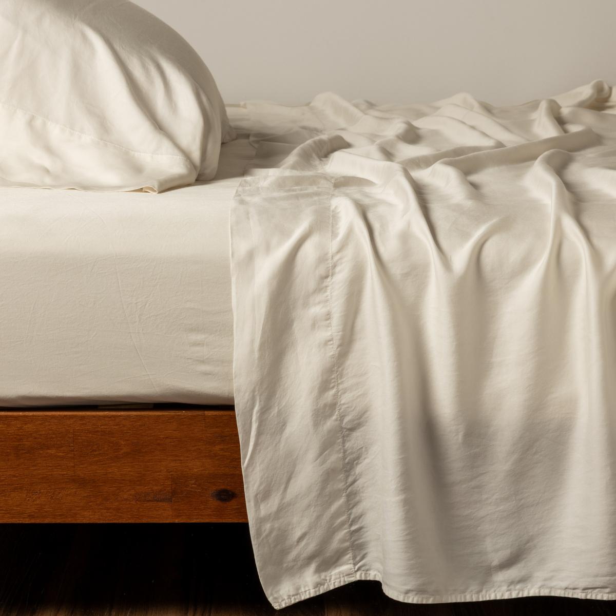 Madera Luxe Twin Flat Sheet | Natural | side view of matching tencel sheets and pillowcase.