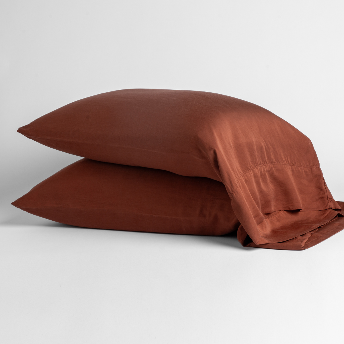 Madera Luxe Pillowcase (Single) | Autumn | A pair of Madera Luxe pillowcases in Autumn, a rich terracotta tone, shown against a white background.