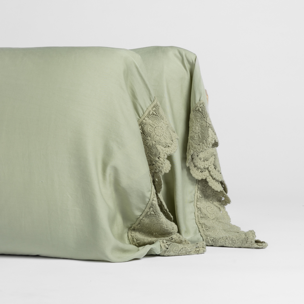 Madera Luxe Pillowcase (Single) | Desert Sage | matching pillowcases with lace in desert sage, a serenely elegant green, offering a hushed hue, shown against a plain background.