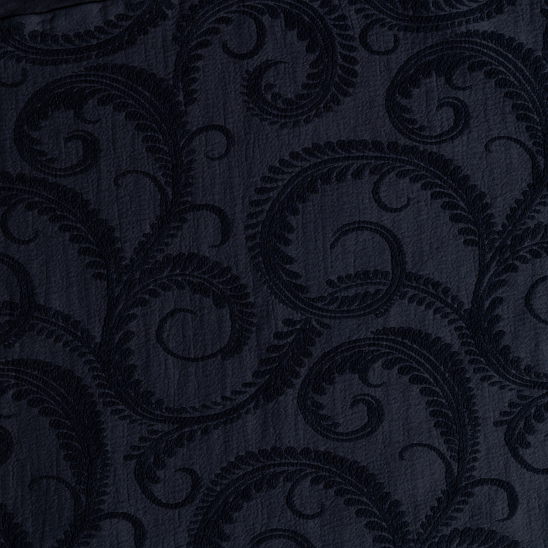 Marisette Bedspread | Slate | a close-up of organic cotton damask fabric in slate, a polished dusky dark blue