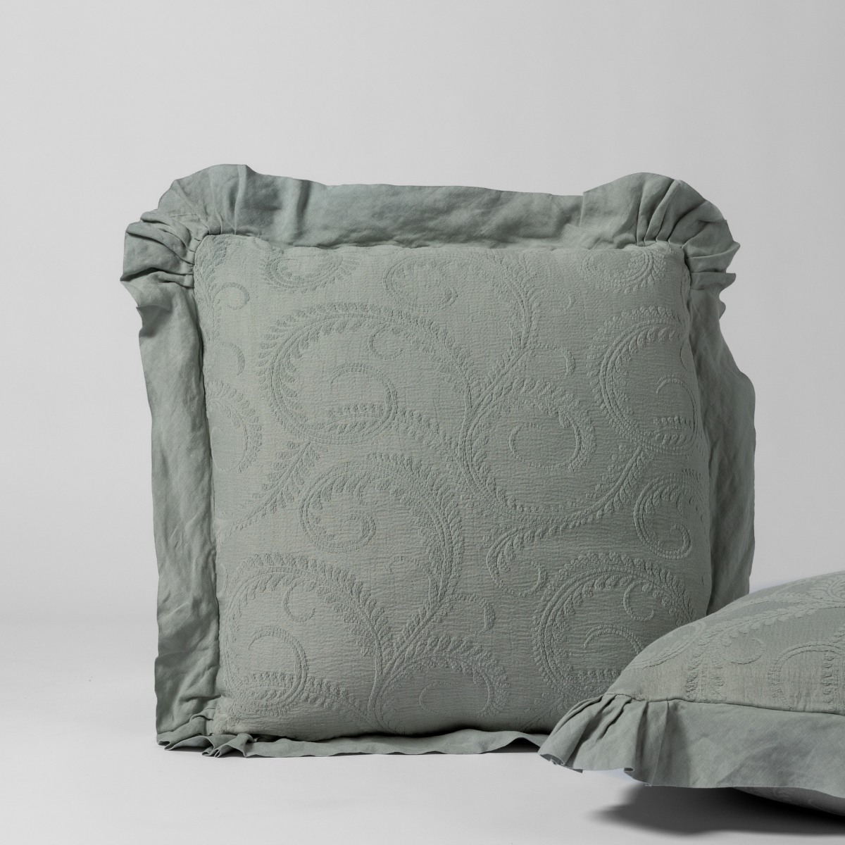Marisette Sham | Eucalyptus | a matching pair of organic cotton damask shams, one upright and one on its side shown against a white background.