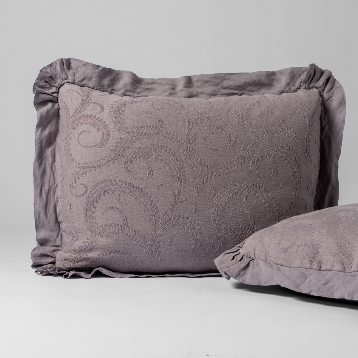 Marisette Sham | French Lavender | a matching pair of organic cotton damask shams, one upright and one on its side shown against a white background.