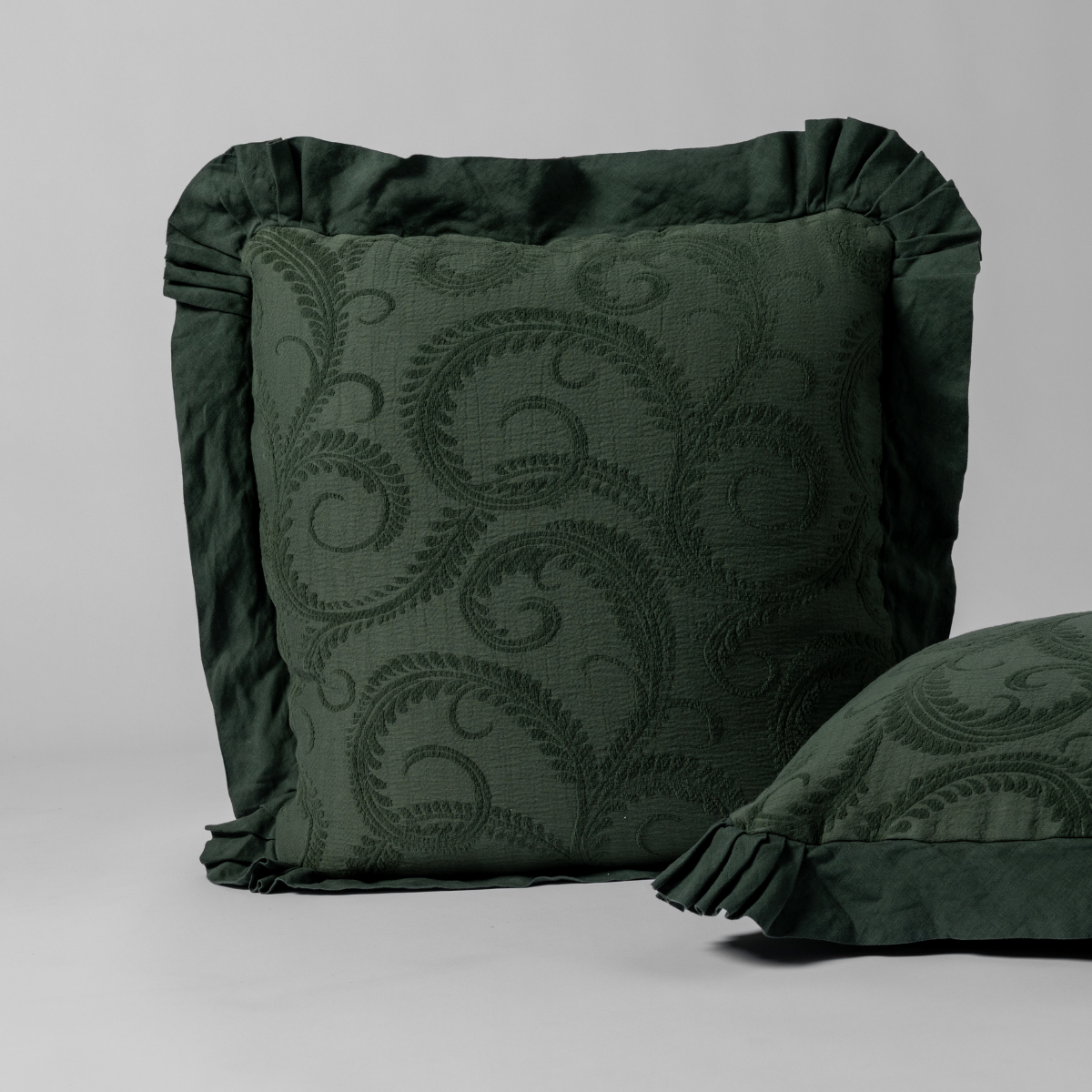 Marisette Sham | Juniper | a matching pair of organic cotton damask shams, one upright and one on its side shown against a white background.