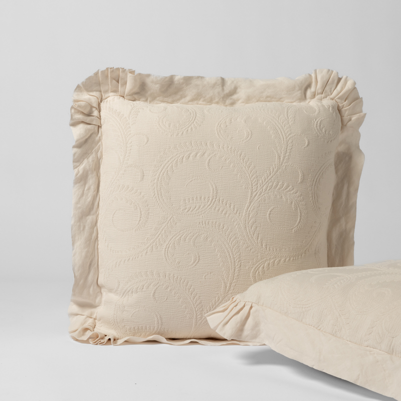 Marisette Sham | Natural | a matching pair of organic cotton damask shams, one upright and one on its side shown against a white background.