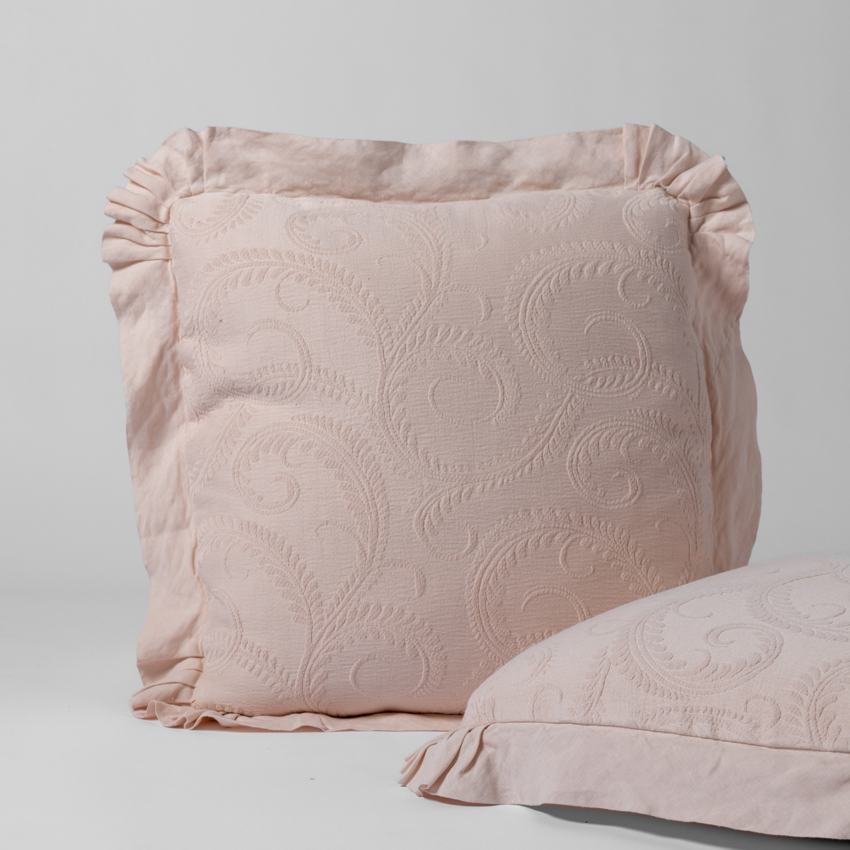 Marisette Sham | Pearl | a matching pair of organic cotton damask shams, one upright and one on its side shown against a white background.