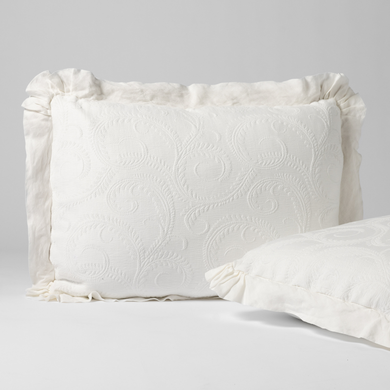 Marisette Sham | Winter White | a matching pair of organic cotton damask shams, one upright and one on its side shown against a white background.