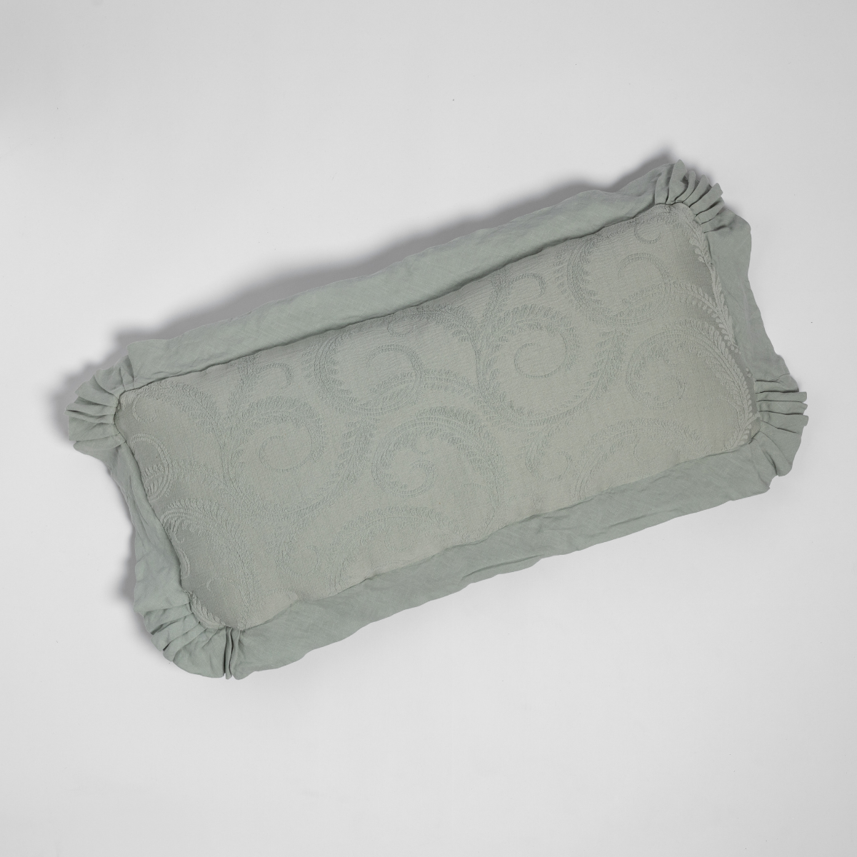 Marisette Throw Pillow | Eucalyptus | an overhead shot of an organic cotton damask throw pillow against a white background.