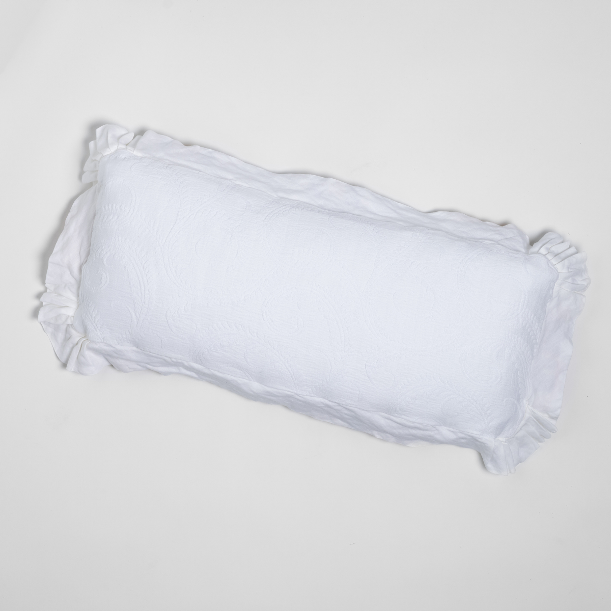 Marisette Throw Pillow | White | an overhead shot of an organic cotton damask throw pillow against a white background.