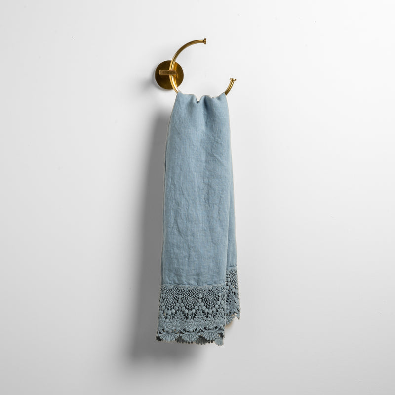 Mattine Guest Towel | Tahoe Blue | linen with mattine lace trimmed guest towel on a decorative towel ring mounted on a white wall.