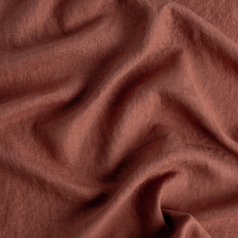 Austin Throw Pillow | Autumn | A close-up of Midweight Linen fabric in the colorway, Autumn, a rich terracotta tone.