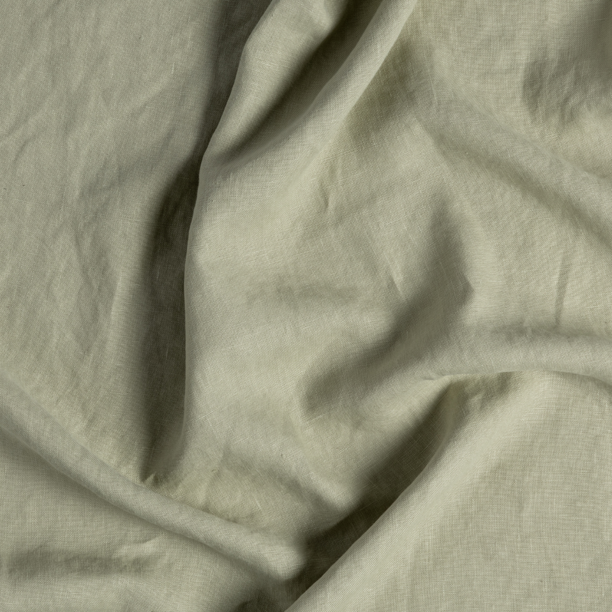 Austin Guest Towel | Desert Sage | close-up of midweight linen fabric gently rumpled in desert sage, a serenely elegant green, offering a hushed hue.