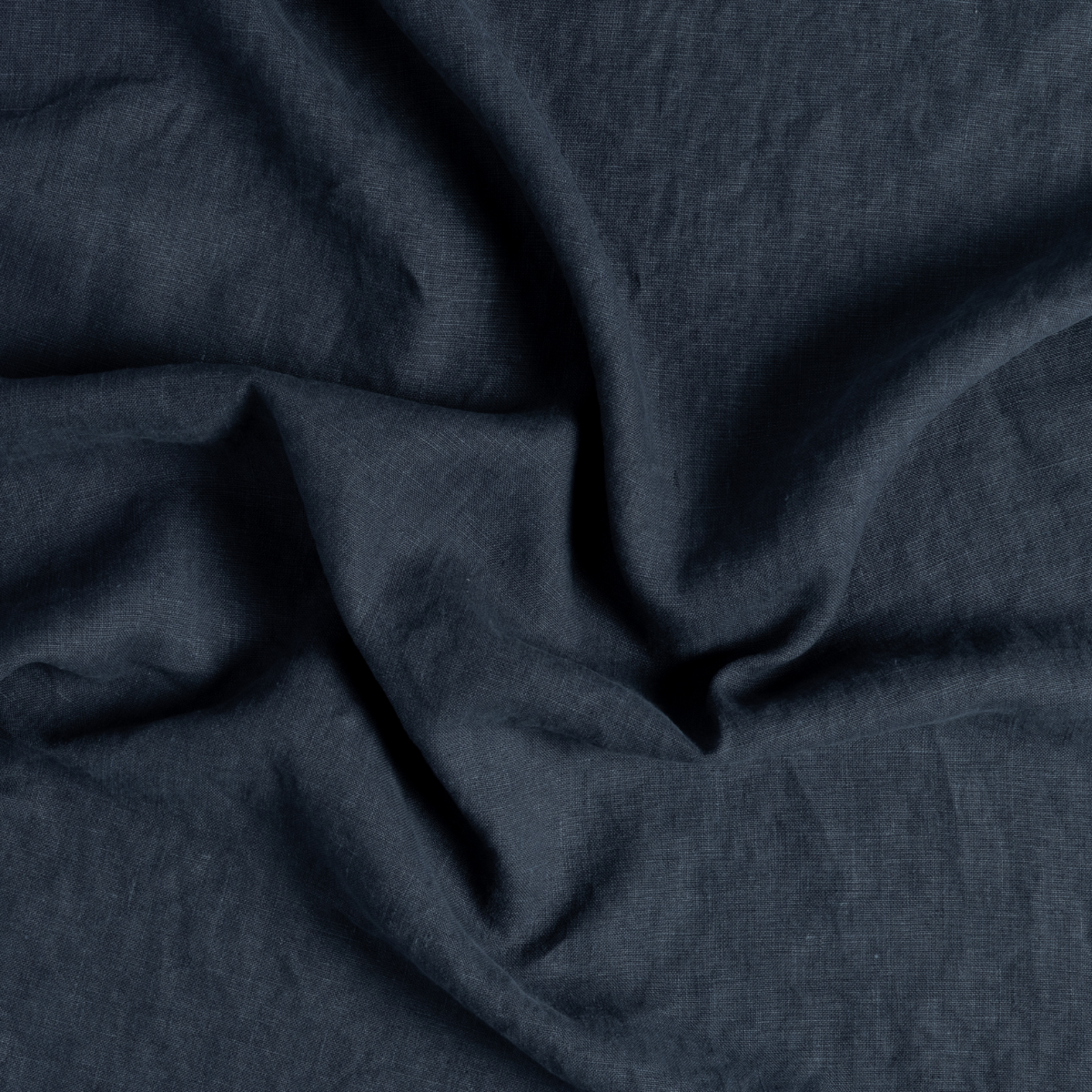 Austin Guest Towel | Slate | a close-up of genttly swirled midweight linen fabric in slate, a polished dusky dark blue