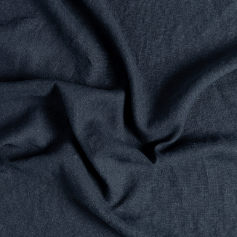 Austin Guest Towel | Slate | a close-up of genttly swirled midweight linen fabric in slate, a polished dusky dark blue