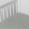 Mirabella Baby Bundle - Holiday Release | Mineral | silk and tencel™ blend jacquard crib sheet shot from above at a slight angle into the corner of a white crib.