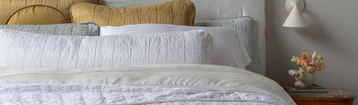 A bend-end view featuring the Sel Collection throw pillows in various sizes and colors