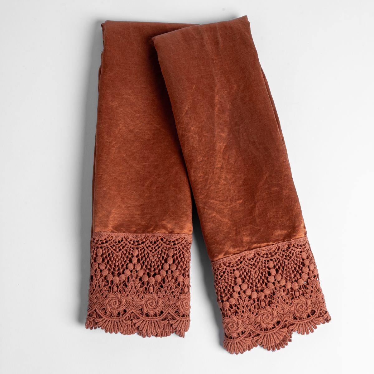 Paloma Pillowcase (Single) | Autumn | A pair of folded Paloma Mattine pillowcases without inserts in Autumn, a rich terracotta tone, shown against a white background.