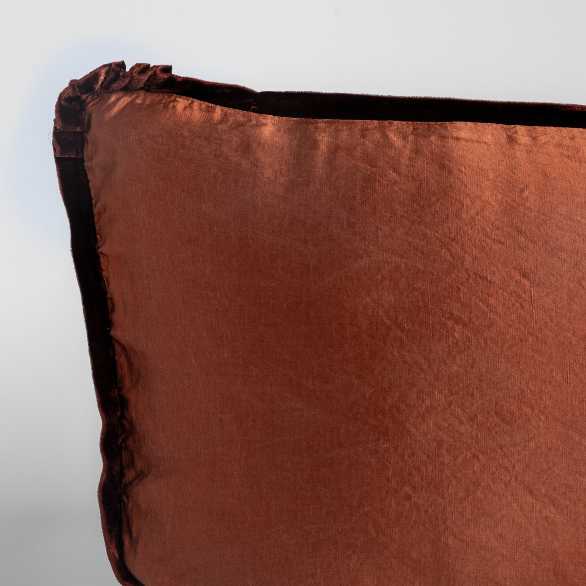 Paloma Sham | Autumn | A close-up of the corner of a Paloma Pillowcase in Autumn, a rich terracotta tone, shown against a white background.