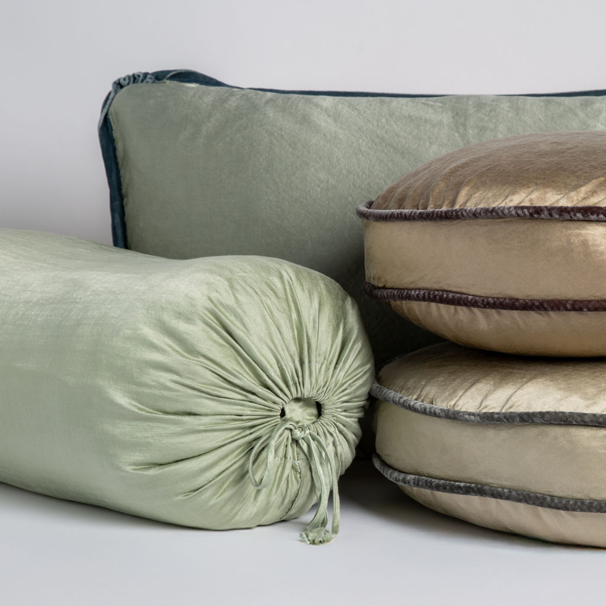 Paloma Throw Pillow | Charmeuse throw pillows from the paloma collection shown in several colors against a white background.