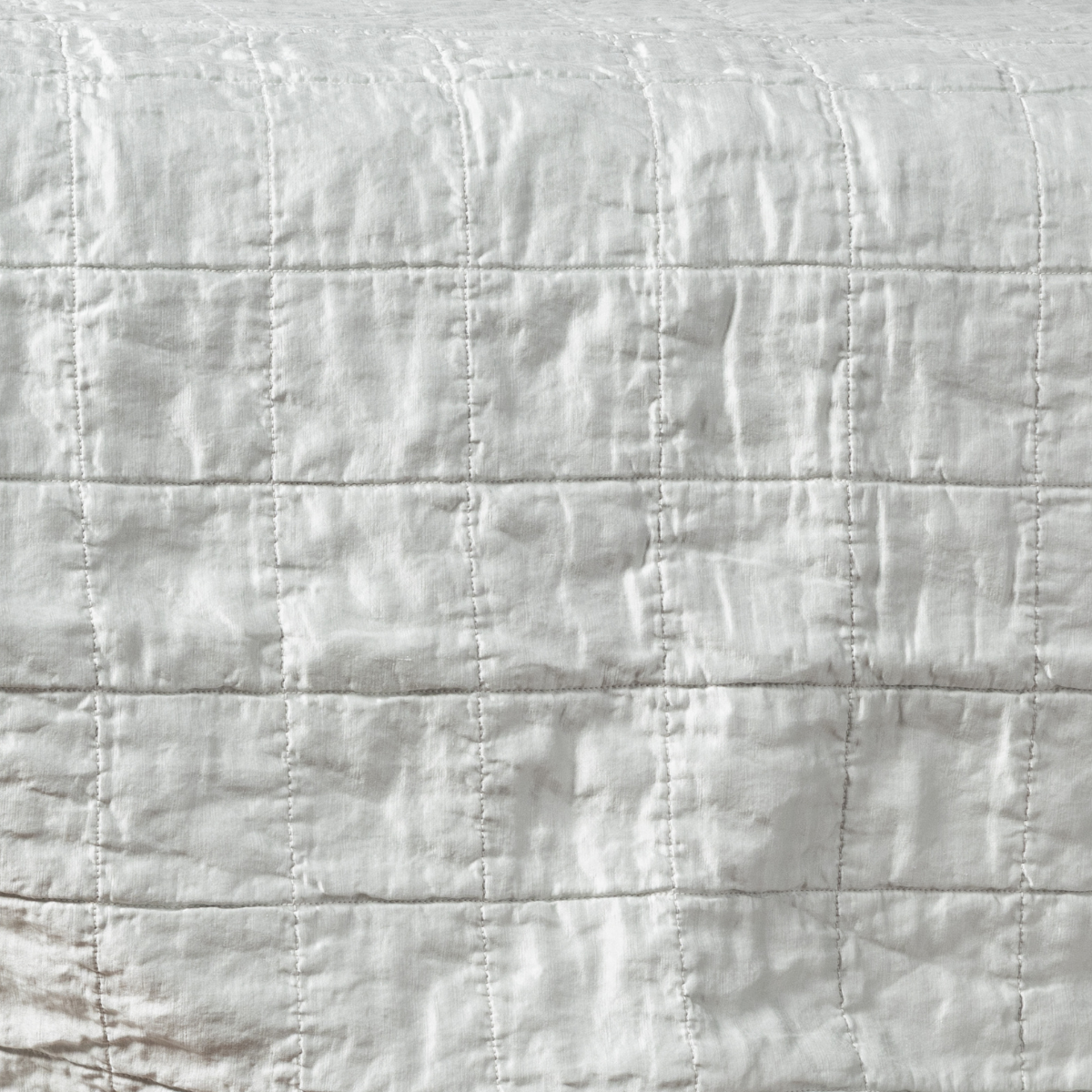 Sel Sham | Cloud | a shot of square-quilted charmeuse in cloud, a subtle sky blue-grey.