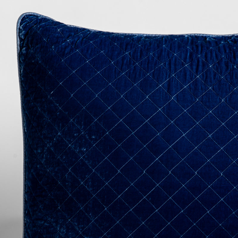 Silk Velvet Quilted Sham | Tahoe Blue | A close-up of a corner of a Silk Velvet Quilted Throw Pillow in Tahoe Blue, a saturated blue like a crystal clear sky, shown against a white background. 