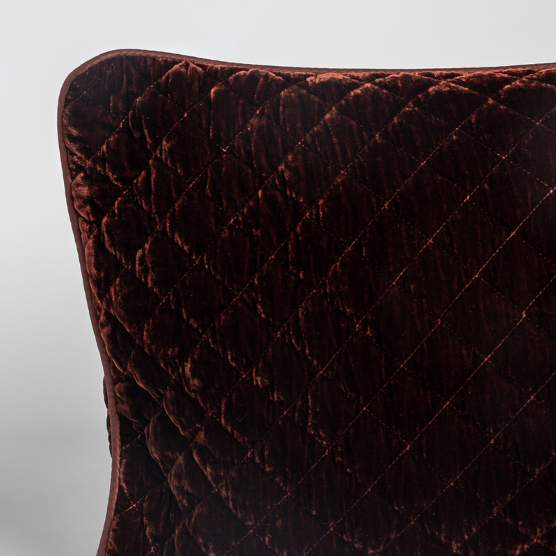 Silk Velvet Quilted Sham | Autumn | A close-up of a corner of a Silk Velvet Quilted Throw Pillow in Autumn, a rich terracotta tone, shown against a white background.
