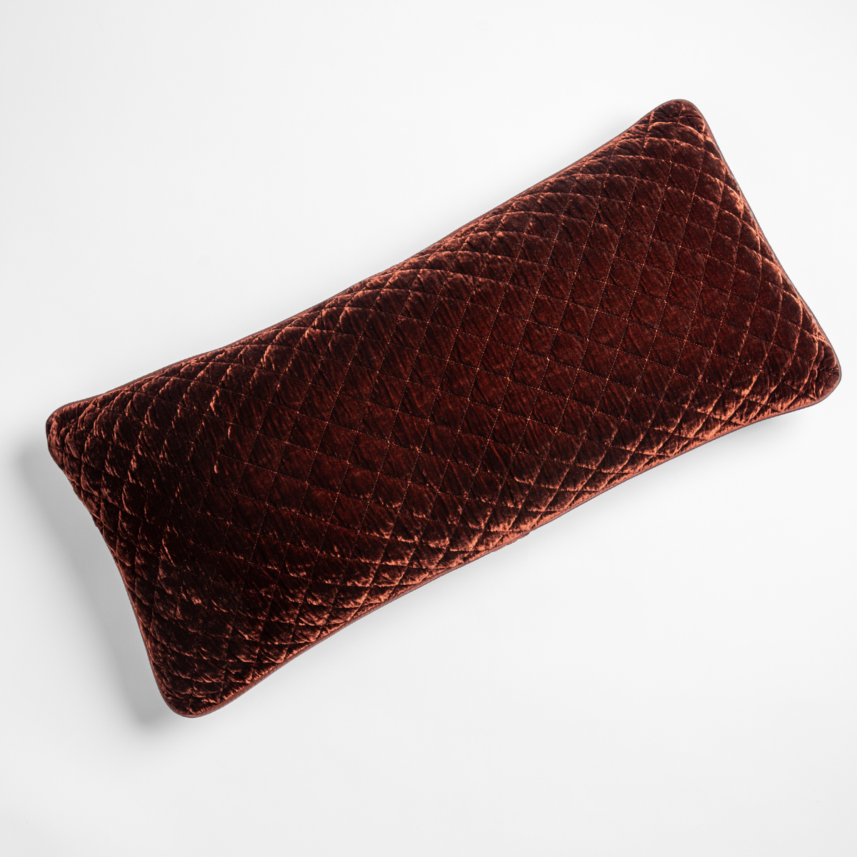 Autumn | A close-up of a Silk Velvet Quilted Throw Pillow in Autumn, a rich terracotta tone, shown against a white background.