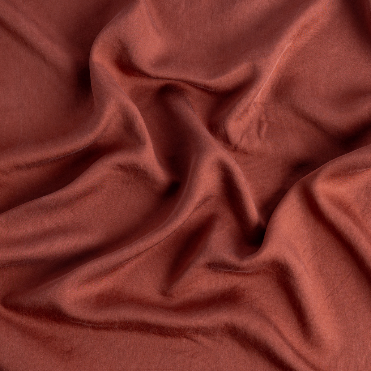 Tencel™ Swatch Card | Autumn | a close up of tencel fabric in autumn, a rich terracotta tone.