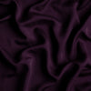 Madera Luxe Crib Sheet | Fig | A close up of Tencel™ fabric in fig, a richly saturated purple-garnet.
